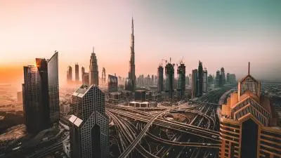 A stunning sunset over Dubai's skyline, featuring the Burj Khalifa amidst modern skyscrapers.